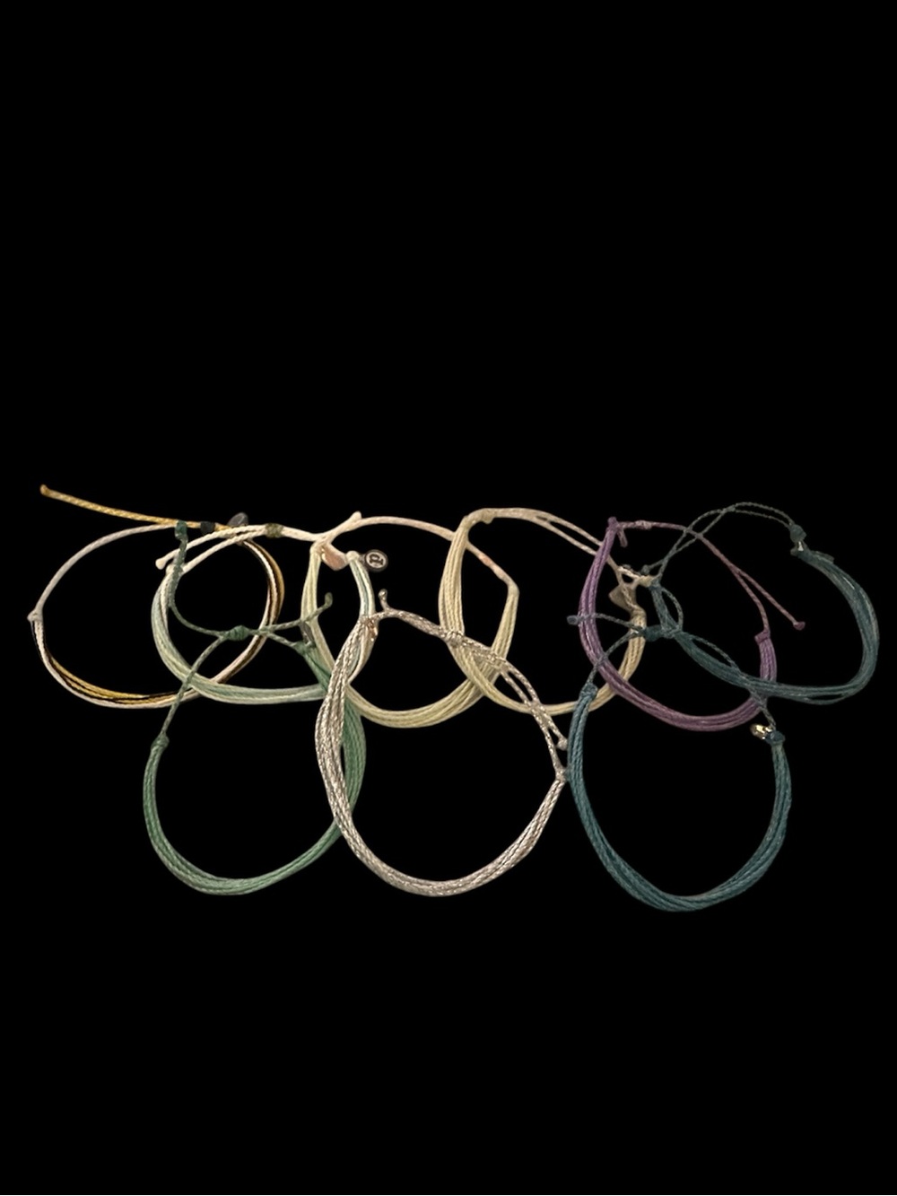 Handwoven wax-coated string bracelets from Pura Vida set of 9